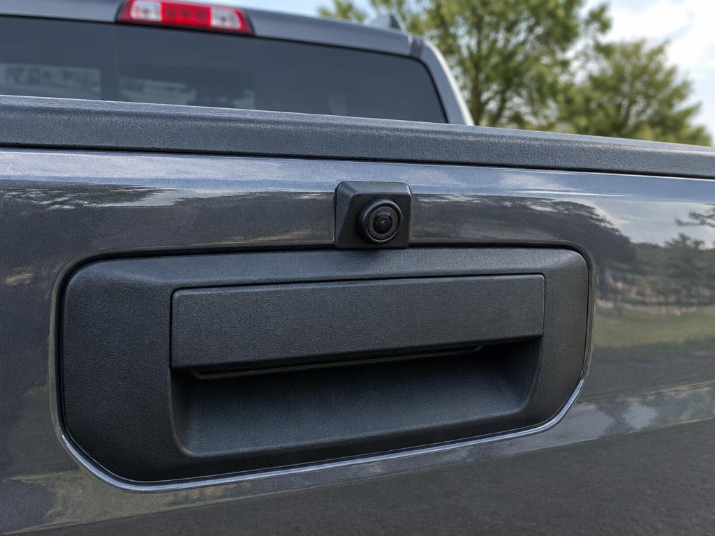 Backup camera mounted above the tailgate handle of a pickup truck