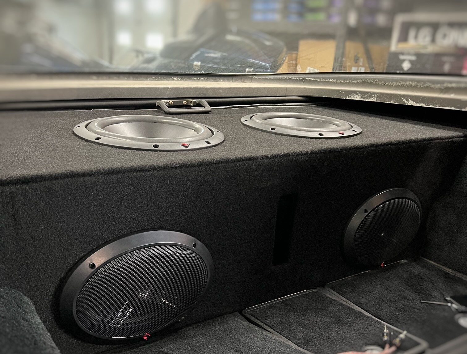Custom carpeted speaker and subwoofer enclosure built into a Corvette rear deck