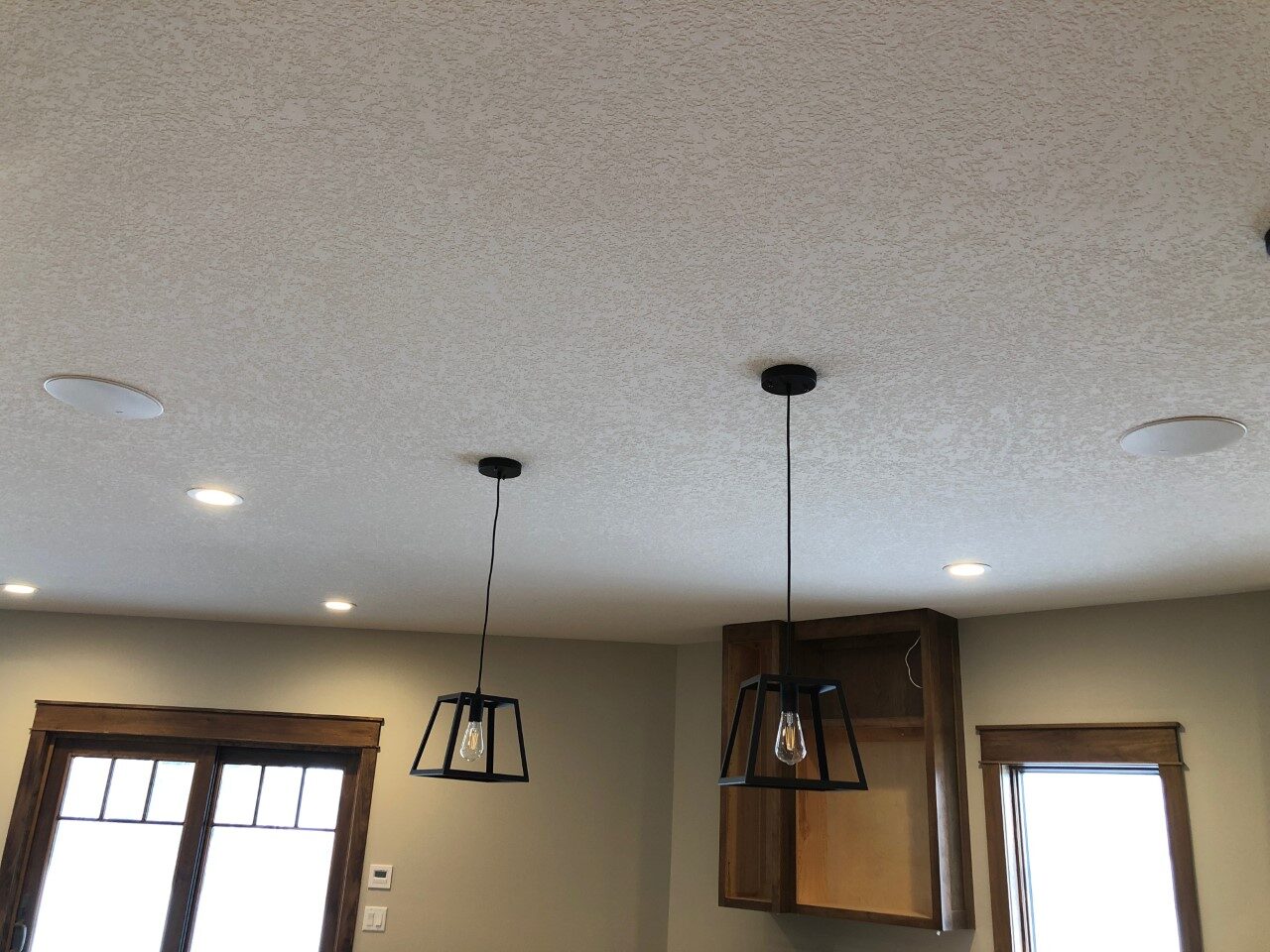 Flush mounted in-ceiling speakers installed in a home kitchen ceiling