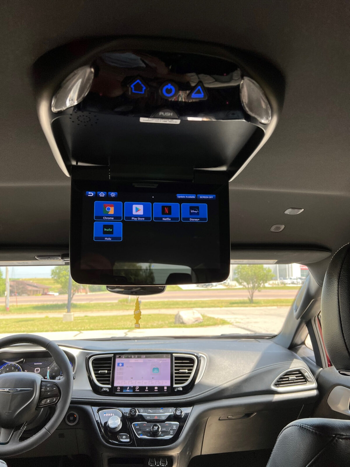 Overhead flip down entertainment screen installed in a minivan headliner